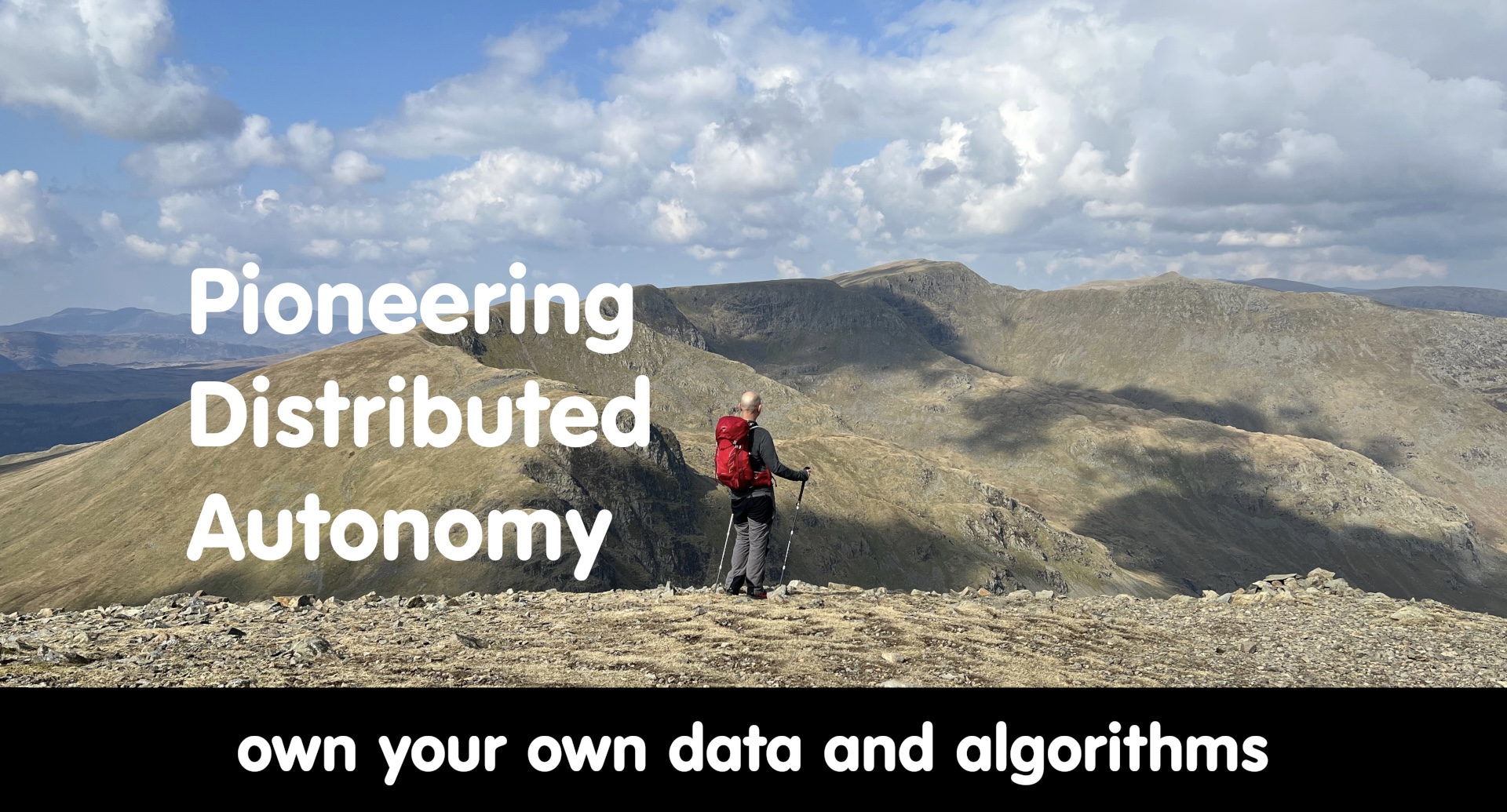 Photo of Stephen Purkiss at the summit of Fairfield overlooking Helvellyn with the words Pioneering Distributed Autonomy to the left and the words own your own data and algorithms underneath